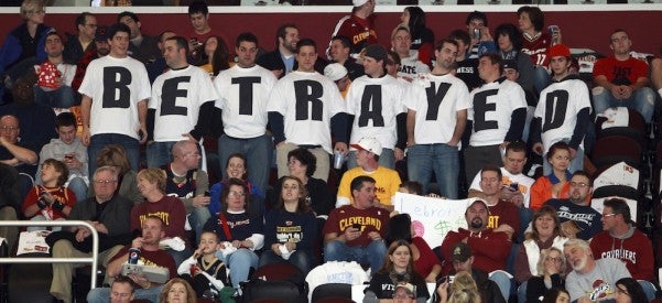 Cleveland Cavaliers fans in Ohio wear shirts expressing their disappointment towards LeBron James, who was with the Cavaliers for seven years before leaving to play for the Miami Heat