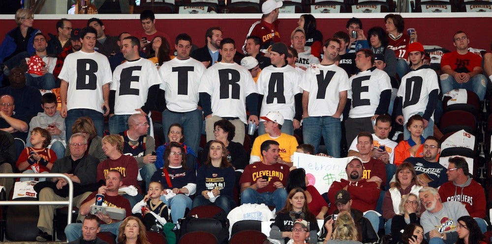 Cleveland Cavaliers fans in Ohio wear shirts expressing their disappointment towards LeBron James, who was with the Cavaliers for seven years before leaving to play for the Miami Heat